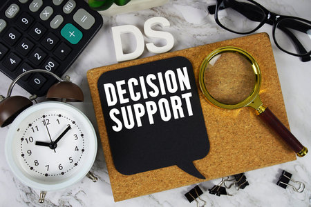 DS Decision Support text with Calculator, alarm clock and magnifying glass on marble background