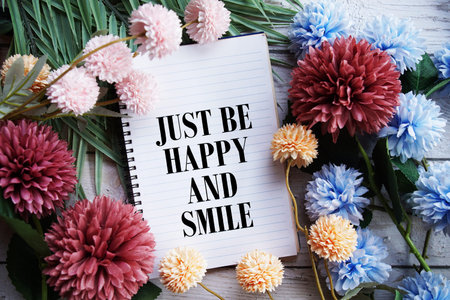 Just Be Happy and Smile Motivational and Inspirational quotes on wooen background