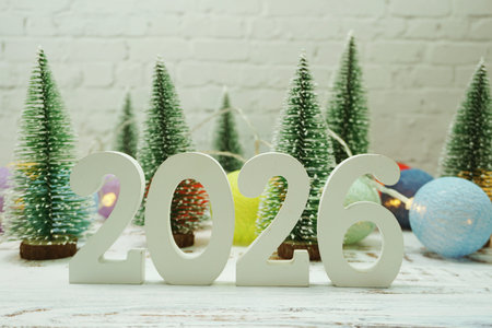 Happy New Year 2026 festive background with christmas tree on white brick wall background