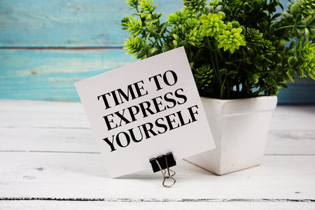 Time To Express Yourself text written on paper card on wooden background