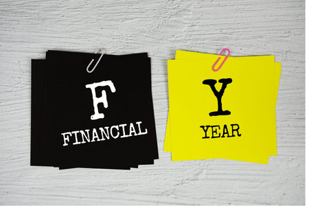 FY - Financial Year text on stick note on concrete background