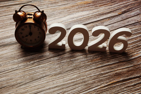 Happy New Year 2026 festive background with space on wooden background