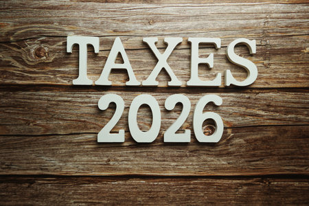 Taxes 2026 alphabet letter on wooden background