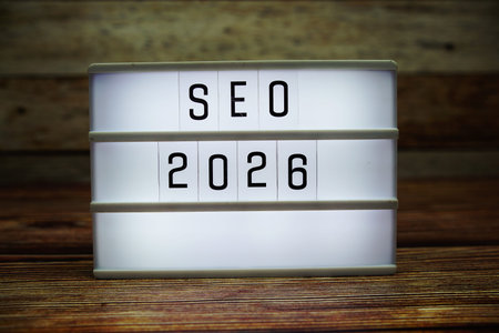 SEO 2026 letterboard text on LED Lightbox on wooden background, business and technology concept...