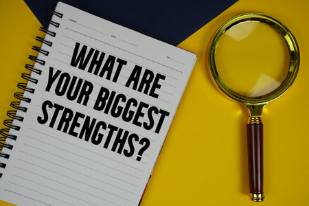 What Are Your Biggest Strengths? text with magnifying glass on yellow background