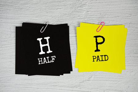 Half Paid text on stick note on concrete background
