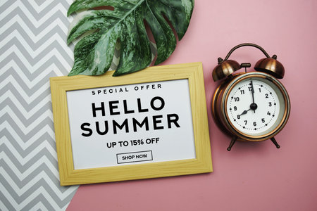 Hello Summer Sale 15% off with alarm clock and monstera green leafon pink background