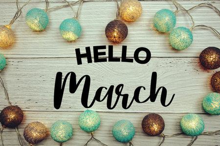 Hello March text with LED cotton balls decorated on wooden background