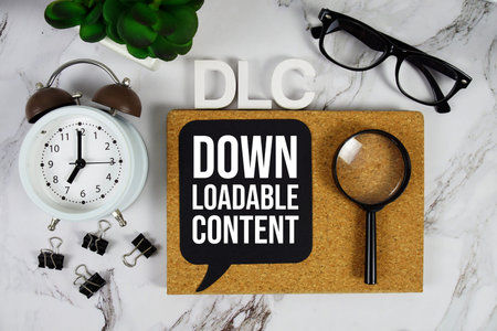 DLC - Downloadable Content acronym with alarm clock and magnifying glass, business concept...