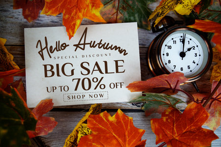 Hello Autumn Big Sale 70% off   Special Offer with maple leaf decoration on wooden background