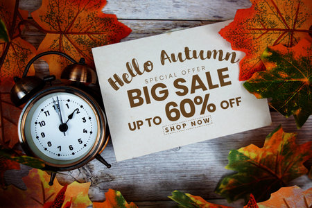 Hello Autumn Big Sale 60% off   Special Offer with maple leaf decoration on wooden background