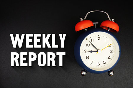 Weekly Report text with alarm clock on black backgroundの写真素材