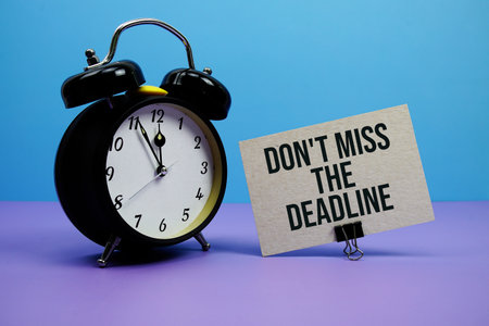 Don't Miss The Deadline text with alarm clock on blue and purple backgroundの写真素材