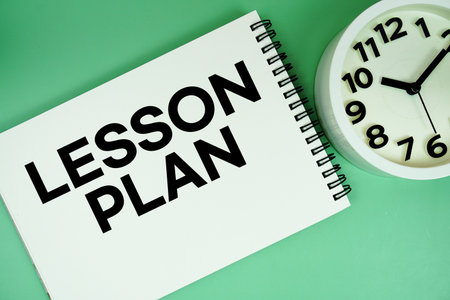 Lesson Plan text with alarm clock flat lay on green backgroundの写真素材