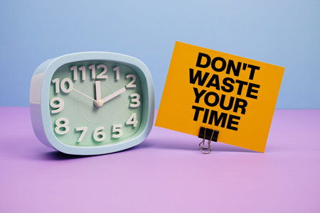 Don't Waste Your Time text and alarm clock on blue and purple background