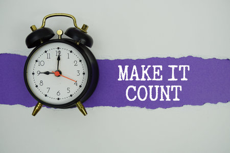Make It Count text on purple with white paper torn ripped of horizontal and alarm clockの写真素材