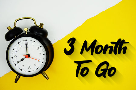 3 Month To Go text and alarm clock on yellow background