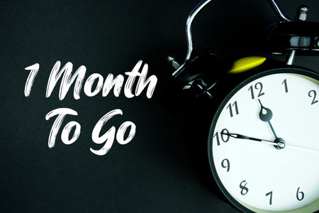 1 Month To Go text and alarm clock on black backgroundの写真素材