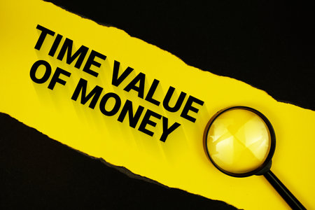 Time Value Of Money text on yellow with black paper torn ripped and magnifying glassの写真素材