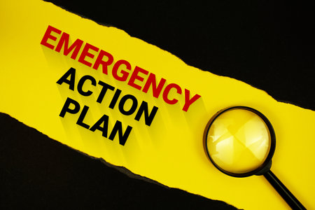 Emergency Action Plan text on yellow with black paper torn ripped and magnifying glassの写真素材