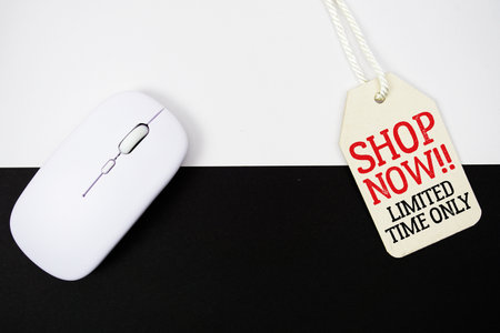 Price tag with Shop Now Limited Time Only and wireless mouse on white and black backgroundの写真素材