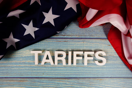 Tariffs letters with usa flag on wooden backgroundの写真素材