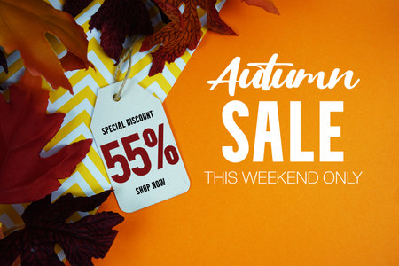 Autumn Sale 55% Off with Price Tag and maple leaf decorated on orange backgroundの写真素材