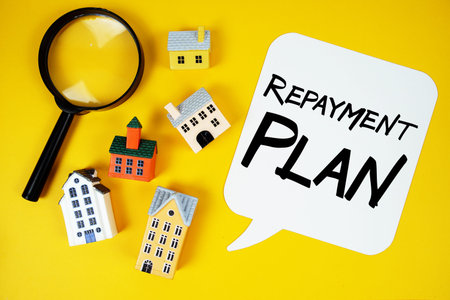 Repayment Plan text with house models and magnifying glass on yellow background