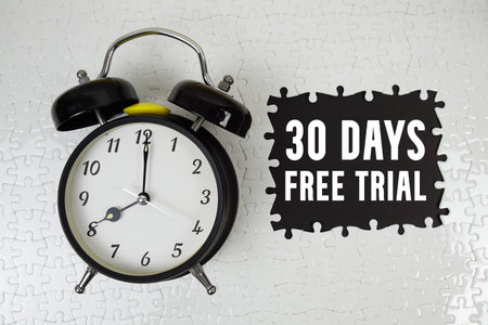 30 Days Free Trial text with alarm clock on black backgroundの写真素材
