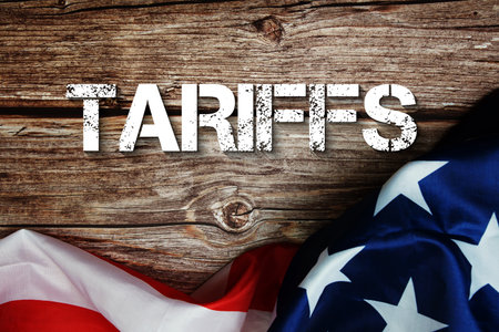 Tariffs text message with USA flag on wooden backgroundの写真素材
