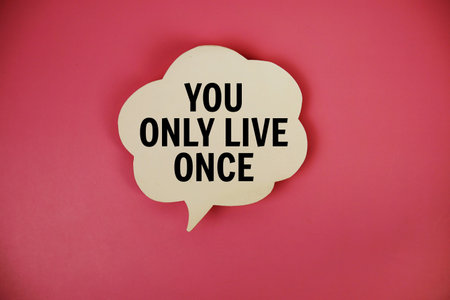 You Only Live Once text with speech bubble top view on pink background