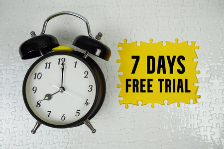 7 Days Free Trial text with alarm clock on yellow backgroundの写真素材