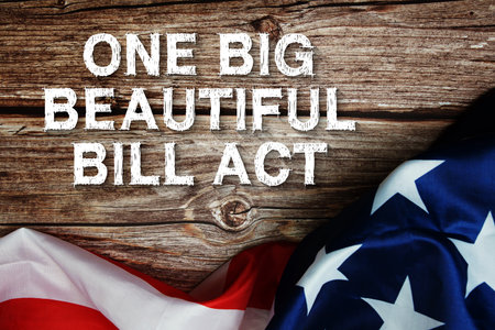 One Big Beautiful Bill Act text message with USA flag on wooden backgroundの写真素材