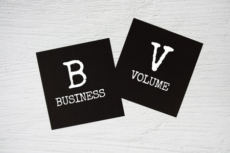 BV - Business Volume text message on stick note on concrete background