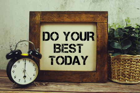 Do Your Best Today text with alarm clock on wooden backgroundの写真素材