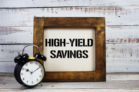 High-Yield Savings text with alarm clock on wooden backgroundの写真素材