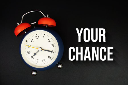 Your Chance text with alarm clock on black background