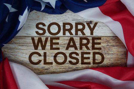 American flag with "Sorry We're Closed" on wooden backgroundの写真素材