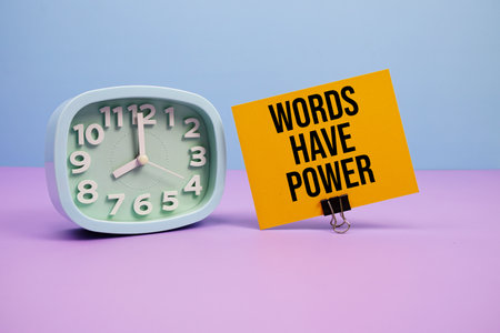 Words Have Power text and alarm clock on blue and purple backgroundの写真素材