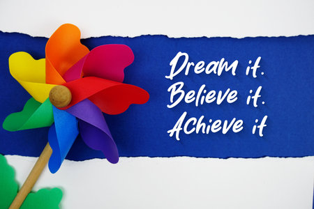 Dream it, Believe it, Achieve it motivational and inspirational quotes message on navy blue backgroundの写真素材