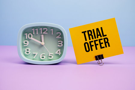 Trial Offer text and alarm clock on blue and purple backgroundの写真素材
