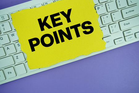 Yellow paper with text "Key Points" placed on a white keyboardの写真素材