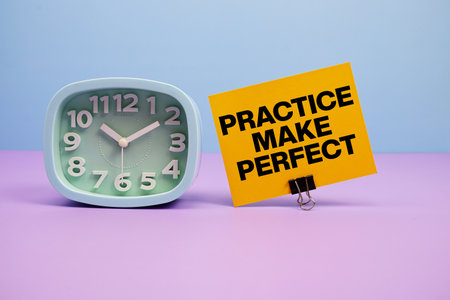 Practice Make Perfect text and alarm clock on blue and purple backgroundの写真素材