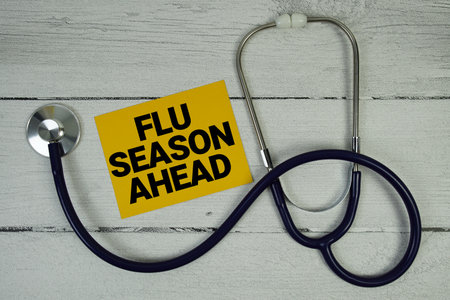 Flu Season Ahead text with Medical Stethoscope on wooden backgroundの写真素材
