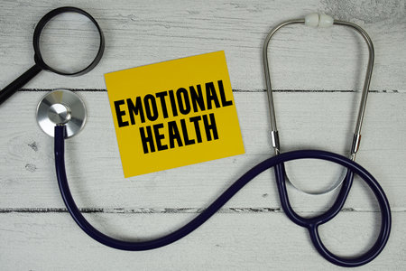 Emotional Health text with Magnifying glass and Medical Stethoscope on wooden backgroundの写真素材