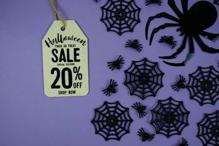 Happy Halloween Sale 20% Off with Price Tag and Halloween elements decorated on purple background