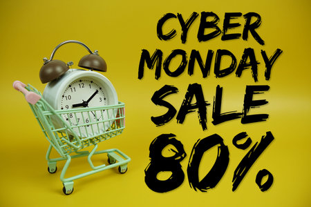 Cyber Monday Sale 80% Promotion and Marketing with trolley shopping cart and alarm clock on yellow backgroundの写真素材
