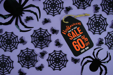 Happy Halloween Sale 60% Off with Price Tag and Halloween elements decorated on purple backgroundの写真素材
