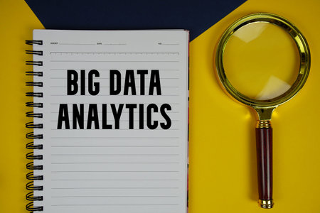 Big Data Analytics text with magnifying glass on yellow backgroundの写真素材