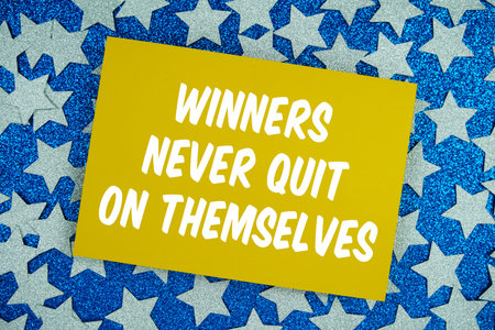 Winners Never Quit On Themselves motivational and inspiration quote on Sparkling Blue Star Backgroundの写真素材
